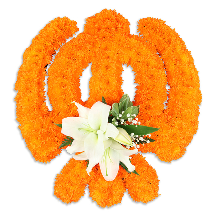A meticulously assembled Ik Onkar rendered entirely in traditional flowers, set against a stark white background that highlights every contour of the sacred mark. The emblem's recognizable elements - the vertical '1' (Ek), the sweeping crescent-like extensions and the final dot - are formed by thousands of bright orange marigold blossoms, packed closely to create a richly textured, celebratory surface. The marigolds' saturated saffron hue radiates warmth and devotion while catching the light to reveal subtle three-dimensionality and a faint shadow beneath, suggesting a crafted panel or freestanding tribute. At the lower centre of the arrangement a cluster of immaculate white lilies provides a serene focal point: at least two fully open lilies with gracefully curving petals and pale green-yellow stamens, accompanied by smaller buds that lend rhythm and anticipation to the design. Sprigs of glossy green foliage and sprays of tiny white gypsophila weave around the lilies, their cool tones balancing the orange and adding delicate depth. The overall effect is contemplative and celebratory at once - a floral Ik Onkar that would suit a home shrine, a Gurdwara event, or a cultural exhibition in Oxford, resonant with the city's interwoven traditions from the High Street to Headington. The piece reads as a respectful offering, crafted with a florist's attention to balance, scent, and texture so that viewers can both see and sense its devotional intent.