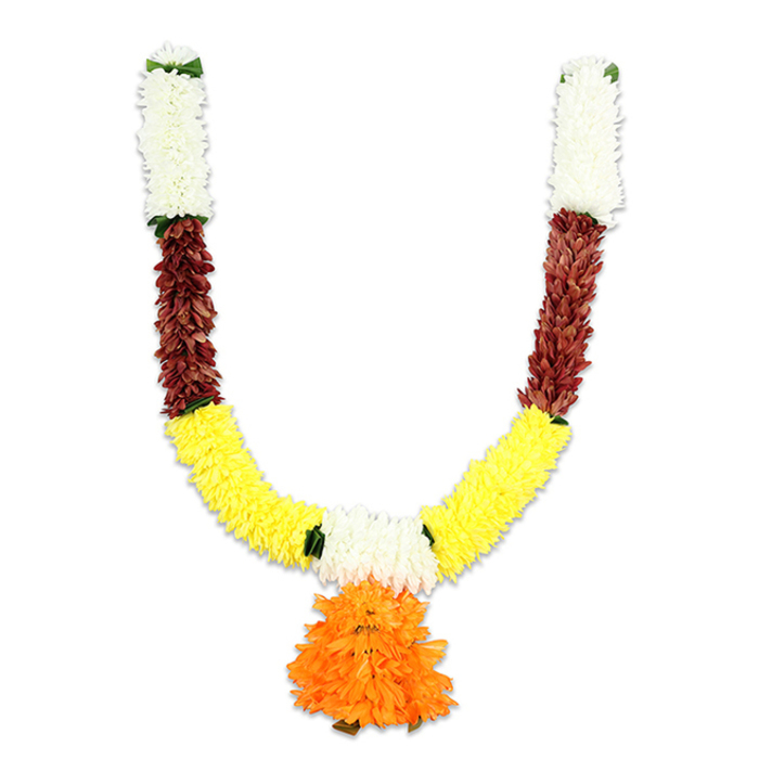 A meticulously crafted U-shaped toran shown on a plain white background, the arrangement layered in distinct colour bands that speak of ritual, welcome and celebration. At the top of each arm are compact clusters of creamy white petals - small, cushiony florets that form a pristine cap and reflect the kind of quiet purity used in puja. Immediately below, a compact strip of reddish-brown elements brings texture and depth; these pieces look like flattened, layered petals or treated natural materials, their warm tones suggesting terracotta or mahogany. The garland then broadens into a generous crescent of vivid yellow, where closely set marigold-like puffs swell into the main body of the U, projecting cheer and abundance. Interspersed between colour blocks are restrained green accents that act as tiny pauses, easing transitions. At the lowest central point a substantial orange pendant hangs - multi-layered and ruffled, it becomes the visual heart of the composition.This is clearly an artificial construction made for longevity: dense threading and overlapping petals lend a rich, full silhouette while keeping the piece surprisingly lightweight for hanging. The studio illumination in the image softens edges and highlights the layered workmanship; one can imagine the texture as silky to the fingertips with an underlying firmness from tightly sewn cores. The colour palette - white, reddish-brown, yellow and orange - is traditionally auspicious and the design balances festive exuberance with devotional sobriety.In the context of Oxford life this garland might be seen welcoming guests in homes near the High Street, framing small community pujas around Cowley or brightening family celebrations in Summertown. Suitable for Diwali, Ganesh Chaturthi, weddings or temple decorations, it reads as a practical, heartfelt heirloom of celebration: visually arresting yet modest enough to carry the quiet dignity of ritual observance.