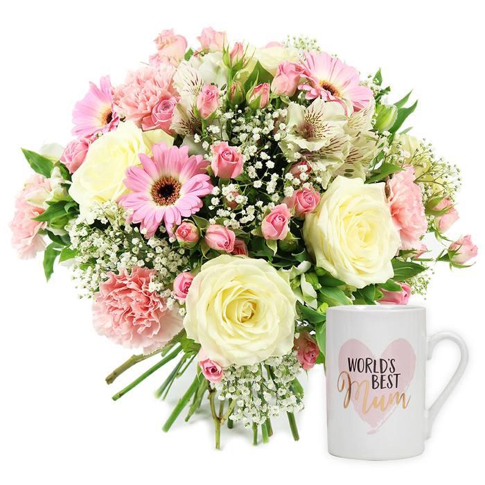 This studio-style photograph captures a graceful Mother's Day or thank-you gift set, carefully composed against a pure white background so every flower and detail is clearly visible. On the left, a hand-tied bouquet sits proudly, its stems gathered neatly at the bottom and splaying slightly, suggesting it has just been lifted from a florist's wrapping on an Oxford kitchen table. The arrangement is rich yet soft, built around large, fully opened roses in a creamy ivory shade; their satin-like petals spiral outward in generous layers, giving the bouquet a classic, romantic core. Surrounding the roses, blush and mid-pink carnations bring intricate ruffles and a sense of movement, while petite spray roses in deeper pink tones tuck into the gaps, creating a full, abundant look. Bright pink gerbera daisies, each with a dark central eye, stand out like little bursts of joy, their daisy heads facing forward to catch the light. Threaded among these are elegant white alstroemeria blooms, each petal slim and slightly flared, marked with fine reddish-brown flecks that add subtle pattern and depth. Veils of tiny white gypsophila blossoms float throughout, softening edges and giving the arrangement a dreamy, cloud-like quality, all balanced by glimpses of fresh green foliage. To the right, a white ceramic mug stands upright, its simple shape and sturdy handle suggesting everyday comfort. The design features a watercolour-effect pink heart, inside which the phrase WORLD'S BEST Mum is displayed-WORLD'S BEST in clear black lettering above, and Mum in an elegant, metallic gold script below. The scene suggests a thoughtful, ready-to-give present, perfect for delivery across Oxford-from leafy North Oxford to the cobbled streets near the Radcliffe Camera-to celebrate a mother's warmth, support, and enduring love.