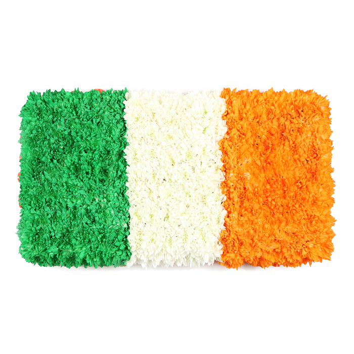 With a quiet, respectful elegance, this rectangular floral flag conveys the Irish tricolour in three defined bands of colour. The hoist side is a deep, verdant green-a plush field of tiny blossoms that feels almost a velvet carpet under light. The central white stripe is a softly luminous band, created from countless white petals arranged to form a cloudlike seam that separates the colour blocks with serenity. The fly end glows orange, its texture mirroring the other two stripes with the same meticulous density of blooms, the hue catching the eye like a warm beacon. Set on a pure white background, the three panels stand in measured proportion, reminding us of balance, restraint, and hope.

Crafted by a skilled team in Oxford, the piece speaks to both heritage and contemporary floristry. The arrangement balances precision with an organic rhythm-an homage to community gatherings on High Street and the University parks, where visitors to the city's libraries, colleges, and markets pause to reflect. If you are featuring Irish identity, cultural celebration, or moments of reflection, this floral flag offers a poignant, palate-pleasing focal point-something that can accompany a ceremony, a commemorative service, or an online feature about heritage. We can arrange delivery across Oxford, from Port Meadow to Summertown, ensuring the colours arrive fresh and true to the design.

The scent is subtle, a fresh, clean whisper of petals, and the texture invites touch without overpowering the senses. The green stripe feels like a soft moss, the white band like a winter cloud, and the orange stripe radiates gentle warmth. This piece is more than decoration; it is a shared language of connection, crafted with care to honour tradition while inviting dialogue. In a city famed for its spires and scholarly life, the floral flag stands as a respectful tribute to heritage, unity, and community-an emblem you can trust to convey meaning with beauty, delivered reliably by a local Oxford florist.