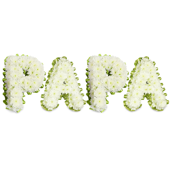 A formally arranged floral tribute that reads PAPA in striking, capital lettering, each letter painstakingly composed of dense clusters of small white chrysanthemums or similar delicate white blooms to produce a soft, pillowed effect. The massing of blossoms creates a volumetric surface with slight doming, the tiny petals overlapping like ripples of quiet snow. Each character is crisply outlined by a slender, ruffled band of pale green ribbon or a fringe of bright foliage, the subtle green edge acting as a defining frame that separates the letters from the pristine white background and gives the overall composition a refined, architectural clarity. The lighting is even and neutral, allowing the textures and tonal contrasts to speak plainly: white for peace and remembrance, green for life and consolation. As a piece designed for funeral settings, memorial services or graveside remembrances, it embodies the generous restraint often chosen to honour a father or grandfather - intimate in the personal name it bears, solemn in execution. There is an understated fragrance of fresh chrysanthemums, faint and comforting rather than bold, and the craftsmanship is evident in the seamless transitions between head clusters and the careful pleating of the ribbon border. In Oxford this kind of thoughtful tribute is commonly ordered for services around the university chapels, near the Botanic Garden, or for families gathering close to High Street and the Covered Market; it reads as a local, compassionate response to loss, conveying a clear message of respect, gratitude and lasting affection for a deceased paternal figure.