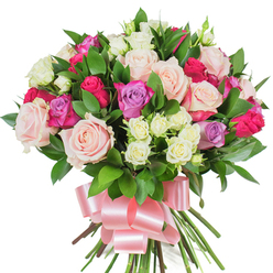 Viewed close-up against a bright white background, this exuberant rose bouquet reads as an expression of careful craftsmanship and soft celebration. The dominant flowers are large, classic roses in creamy white and blush pastel pink, their layered petals unfurling to reveal velvety textures that suggest a gentle, familiar rose scent. Striking hot-pink or deep fuchsia roses are placed for contrast, their vivid tones drawing the eye, while lavender roses add a quiet, romantic coolness that balances the composition. Scattered between the larger blooms are tight clusters of spray roses, pale cream tipped with whispers of yellow, which give the arrangement tactile variety and a playful, small-scale rhythm. Dark green glossy foliage-likely ruscus or salal-peeks through and around the flower heads, its smooth, resilient leaves providing structure and a verdant backdrop that makes the colours pop. The stems are tied together low and neatly, finished by a broad satin ribbon in soft baby pink, formed into a generous bow whose sheen softens the silhouette and suggests a thoughtful, hand-finished touch. The studio light is even and clean, letting each petal and leaf hold its true tone. As a local florist might say, this bouquet is designed to convey love, thanks, or celebration-and it's suited to delivery across central Oxford, from St Giles to the Botanic Garden, for moments requiring warmth and refined charm.