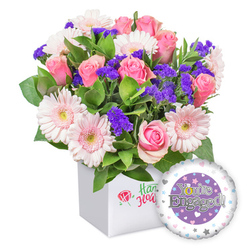 This joyful bouquet from Flowers Oxford marries blush pink roses with pale pink gerberas, their petals edged in white and centers softly pale, creating a romance-filled centerpiece. Interleaved among the blooms are generous clusters of rich purple statice, adding depth and cheer, while fresh green foliage provides a lush, garden-like backdrop that feels harvested from a sunlit Oxford market. The arrangement sits in a pristine white square box, its front bearing a subtle red rose emblem and elegant green script that speak to a trusted local craft. Beside the bouquet, a round engagement-themed balloon floats, its panel set against a deep purple circle and carrying the message "You're Engaged!" in silver letters, accented by a gleaming golden 'O' in the word, all framed by a white outer ring speckled with pastel hearts and tiny silver stars. This contemporary gift exudes warmth and thoughtfulness, a perfect congratulations for an engagement shared in Oxford's city centre, or along Cowley Road and Port Meadow routes, where friends and family gather to celebrate. We're proud to offer reliable delivery around Oxford, with graceful service that reaches from Broad Street to Summertown, ensuring the moment is marked with beauty and care.
