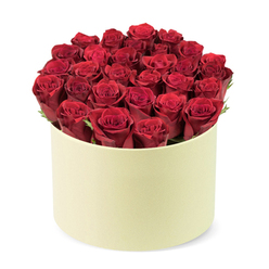 In the Flowers Oxford studio near Jericho, this arrangement gathers about two dozen deep red roses, their velvety petals at their peak, arranged in a champagne-beige hat-box with a satin-like finish. The blooms stand in a flawless, dome-shaped formation with a calm symmetry that feels both luxurious and contemporary, and there are no visible stems or leaves, allowing the crimson to sing. The box's smooth matte surface provides a tactile contrast to the plush petals, while the three-quarter elevated view against a clean white backdrop highlights the careful craftsmanship of the bouquet.

The light is soft and diffuse, caressing the blooms and inviting the viewer to imagine the scent rising from the arrangement. This composition speaks of care and expertise; every bloom seems chosen by a hand that knows Oxford's romantic traditions. It's the kind of gift that says I'm thinking of you without shouting, perfect for Valentine's Day, anniversaries, or milestone birthdays. Flowers Oxford offers same-day delivery across Oxford city centre, Cowley Road, Summertown, and nearby neighborhoods, ensuring the moment arrives as beautifully as it is imagined.