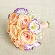 This luxurious bouquet, composed by expert Oxford florists, captures the fresh, contemporary spirit of city weddings while nodding to classic romance. Artistic and thoughtfully arranged, its star blooms are full, softly scented roses in luminous peach and apricot-each adorned with creamy, blush-laced petals that seem to glow beneath gentle daylight. White lisianthus blossoms with striking violet edges interrupt the warm palette, lending a modern twist to the traditional round, compact shape. Wisps of baby's breath weave throughout, creating a dreamy, cloudlike effect, softening every edge like morning mist over Port Meadow. The stems are neatly hand-tied and elegantly wrapped with a peach satin ribbon, further embellished by small, lustrous pearls set in a subtle pattern, ensuring comfort and style for a bridesmaid or party guest. Lying atop a lightly textured, oatmeal-hued cloth, the arrangement radiates a sense of optimism and refined joy-ideally suited as a bridesmaid bouquet for Oxford's historic venues or a statement piece for gatherings in Jericho or Summertown. This image brings to mind spring and summer celebrations filled with laughter and hope in the heart of Oxford.
