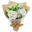 A hand-tied bouquet stands upright against a clean white backdrop, a study in crisp white blooms and deep green foliage arranged with confident, experienced hands. At the heart of the composition sits a generous cluster of white, daisy-like chrysanthemums whose many narrow petals fan out around sunny yellow centres, offering a cheerful, familiar focal point. Interwoven among them are elongated, pale green-yellow lily buds, some faintly striped, still closed and promising the drama of opening petals in the days ahead; a few lilies show the first hint of unfurling, lending graceful vertical accents. Fine sprays of baby s breath (Gypsophila) drift through the larger flowers like soft, white clouds, bringing an airy texture that softens the bouquet and makes the whites feel luminous rather than stark. Rich, glossy leaves and stems in deep green cradle the blooms and heighten the contrast, their smooth texture visible against the petals. The florist has wrapped the stems first in rustic, crinkled brown kraft paper for an earthy, handmade feel, then protected the arrangement with a clear, glossy cellophane outer layer that catches the light and gives a polished sheen. The base is neatly gathered and tied, creating a stable, portable stand for easy carrying. In gentle morning light this bouquet reads as pure and reassuring, its scent subtle and clean with a hint of grass after rain. It is equally suited to quiet sympathy, a fresh new-beginning gift, or a thoughtful congratulations. Imagined on a stroll through Oxford near the Covered Market or St Giles, it feels like a considerate, locally made offering from a trusted neighbourhood florist.
