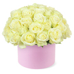 A lavish cluster of roses in soft cream and pale ivory rises from a round pastel pink hat box, forming a perfectly rounded dome of petals that feels both modern and deeply romantic. The box, with its smooth, matte blush finish, acts as a minimalist pedestal for the ornate display of blooms, its gentle pink tone subtly amplifying the warmth in the roses' creamy hues. Each flower appears carefully selected and placed, with velvety petals unfolding in classic rosette shapes that overlap and nestle against one another, creating a dense, cloud-like surface. In the centre of some blossoms, a hint of lemony yellow glows softly, suggesting the freshness of roses that have just been conditioned and arranged the same day. Tiny suggestions of green foliage peek around the lower edge of the dome, grounding the design in nature while keeping the visual focus firmly on the abundant, pale blooms. Set against an uncluttered white background, the arrangement becomes the sole point of attention, every curve and shadow gently illuminated as if by natural daylight through an Oxford townhouse window. The mood is one of thoughtful indulgence and quiet celebration, evoking anniversaries marked with dinner reservations near the Covered Market, or surprise flower deliveries arriving at offices around the science parks and central colleges. It feels like a design created by a local hand-someone who understands how Oxford couples celebrate key moments-combining the enduring symbolism of white and cream roses with the chic appeal of a hat box presentation, ideal as a romantic gift, refined centrepiece, or elegant gesture of appreciation.
