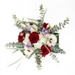 Gazing down from above, one is greeted by a radiant bouquet vividly composed by one of Oxford's expert florists-each bloom carefully chosen and arranged for both character and emotion. The deep, velvet embrace of red roses sets a romantic undertone, each petal unfurling with purpose and grace, much like Oxford's historic hearts beating within its ancient walls. Nestled beside these are cheerful white gerbera daisies, their prominent dark centers echoing the inviting warmth found in the city's beloved cafes and bookshops. Around them, billowing tufts of delicate white chrysanthemums lend a sense of airiness, conjuring the calm of morning fog over the Thames. Sprigs of cool, silvery eucalyptus arch outward, releasing a crisp, verdant scent that quietly evokes riverside strolls through University Parks in spring. Gentle touches of pale lilac lisianthus thread through the arrangement, their soft, elegant petals offering both playful lightness and subtle depth. The interspersed green foliage binds the composition, echoing Oxford's lush outdoor spaces and inviting a feeling of ongoing renewal. Bathed in pure, diffuse light, the bouquet glows with vitality and style-making it a perfect centerpiece for winter celebrations, thoughtful gifts, or moments of gratitude delivered to any doorstep across Oxford's lively communities.