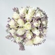 There's an effortless serenity in this bouquet-a sense of Oxford's own understated elegance captured in flowers. Crisp white roses, their petals snowy and layered, form the centerpiece, each spiral suggesting unwritten stories and trusted confidences. Between them, fine sprays of lavender statice add a gossamer texture and a whisper of colour, like morning mists curling along the Cherwell River. The hint of green leafage grounds the composition, echoing the natural calm of University Parks. Soft, natural light bathes the bouquet, enhancing the velvety texture of each petal and setting the blooms aglow against a calm, pale background. The arrangement radiates quiet optimism and goodwill-perfect for moments of connection, be it a gentle gesture of comfort or a celebration with friends in Summertown. This bouquet, crafted with the attentive artistry of an Oxford florist, remains in memory as a breath of tranquil beauty-a testament to the enduring warmth that flowers can offer in the heart of Oxford.