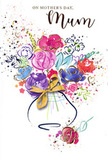 This Mother's Day card is designed like a joyful, hand-tied bouquet captured in watercolour, as if painted after picking flowers from an Oxfordshire cottage garden. Lush purples, playful pinks, radiant reds, and serene hints of blue crowd together in a loose, overflowing arrangement that feels both spontaneous and thoughtfully composed. The petals are suggested with soft, translucent washes of colour overlaid by confident strokes of deeper pigment, while fine touches of gold add a subtle shimmer, catching imagined light like sunshine on glass vases in a local Oxford flower shop. The blooms gather at the centre in a bright, uplifting mass, then taper into lighter splashes and heart-like motifs that drift around the edges, creating the impression of petals tossed in celebration. Beneath the centre of colour, a gentle, rounded vase is painted in muted tones, its form simple but welcoming, finished with an elegant golden bow that recalls the quiet rustle of ribbon being tied with care. The white background keeps the design airy and clean, so every hue stands out, much like blooms displayed against fresh tissue paper before delivery across areas like Kidlington, Iffley, or central Oxford. There is a sense of heartfelt anticipation in the composition, as though the bouquet is just waiting to be lifted and presented with a smile. The card radiates gratitude, warmth, and the comforting reassurance that a mother's love is cherished and celebrated, turning painted flowers into a lasting gesture of thanks.