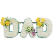A deeply personal memorial piece spelling DAD in three large, freestanding capital letters, each letter lovingly built from a dense blanket of pristine white spray chrysanthemums that give a soft, pillowy texture and a uniformly calm surface. The outer and inner edges of every letter are neatly bordered with a ruffled, dark green satin ribbon that reads as a crisp halo against the white blooms, while slim, dark green metal support bars run horizontally behind the letters, subtly visible and anchoring the trio into a single cohesive tribute. On the left D a vibrant cluster of sunlit yellow roses-three to four blooms-sits on the upper curve, warmed by tiny white freesia or gypsophila accents and fresh green foliage; two long, slender green stems arch upward and diagonally toward the A, creating a gentle visual bridge. The central A is finished with a dignified cluster on its lower diagonal, where two deep purple-burgundy calla lilies stand like small fluted trumpets amid pale filler blooms and glossy leaves, lending a quiet, reverent focal point. The right D mirrors the left with the same cheerful spray of yellow roses and creamy white accents, balancing the composition. Presented against a clean white background with soft studio light that accentuates texture and shadow, this arrangement suggests the faint, clean scent of freesias and roses and the careful hand of a floral artist. As a sympathy tribute intended for a funeral or memorial service in and around Oxford-from Summertown to Cowley-this bespoke DAD arrangement offers solemn comfort, crafted to honour a father with clarity, balance, and heartfelt intention.