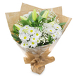 This image shows a carefully crafted white and green bouquet standing upright against a clean white background, every bloom clearly defined as if lit by soft window light from a quiet Oxford side street. The arrangement is dominated by round clusters of white daisy-like chrysanthemums, each flower composed of rows of fine, crisp petals radiating from a bright yellow-green disc at the centre. These daisy flowers create a cushion of softness that feels welcoming and serene. Rising above and between them are several elongated, unopened lily buds, their smooth, tapering forms shaded in gentle greens and creams. They tilt upward with quiet elegance, suggesting blossoms that will gradually open over the next few days, extending the life and meaning of the bouquet. Sprinkled throughout are filigree stems of white baby's breath, their multitude of tiny star-shaped flowers lending a weightless, cloud-like texture that softens the whole composition. Dark, glossy green leaves frame the arrangement, providing a structured outline and a deep, natural contrast to the white petals, much like the lush greenery along the paths of South Park. The stems are bound at the base and wrapped in rustic brown kraft paper, its folds and creases adding a touch of handmade charm and natural warmth. Around this, a layer of transparent, slightly crinkled cellophane encases the bouquet, catching subtle highlights and protecting it for delivery to homes and chapels around Oxford. The bouquet conveys a mood of quiet sympathy, purity, and gentle hope-an understated yet heartfelt way to express condolences or send peaceful wishes to someone in Jericho, Summertown, or near the city centre.