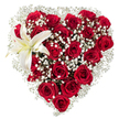 A meticulously crafted heart-shaped bouquet sits against a crisp white backdrop, its silhouette formed from dozens of deep crimson roses whose velvety petals unfurl in varied stages - from tight, whiskey-dark buds to fully opened, plush blooms catching soft highlights. Between the roses, airy clusters of tiny white baby's breath (Gypsophila) drift like pale, feathery clouds, softening the heart's edges and creating delicate negative space that lifts the intense reds. Nestled in the upper left curve of the heart is a single sculptural white lily: broad, pristine petals edged with a whisper of creamy yellow toward the throat and tipped by warm yellow-orange stamens that offer a gentle focal contrast. The overall composition reads as a celebration of passion and tenderness - the dense, tactile weight of the roses balanced by the lily's serene purity and the gypsophila's lightness. Light is even and studio-clear, isolating texture, color and shadow so each petal, sepal and filament is legible to the eye and evocative to the imagination. If you imagine scent, the heady, familiar perfume of garden roses meets the clean, slightly sweet lily note, softened by the powdery breath of gypsophila - a bouquet meant for quiet, honest declarations: anniversaries, heartfelt apologies, or a romantic gesture when words are small. As a local florist in Oxford might arrange for a city centre delivery, I picture this piece wrapped gently and sent across to a room near the Radcliffe Camera or laid with care at a bedside beside the lights of High Street, its emotional clarity unchanged by distance.
