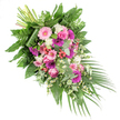 Set against a simple white background, this thoughtfully composed funeral spray forms a sweeping diagonal from top left to bottom right, as though guiding the eye along a gentle journey of farewell. At its centre, generous gerbera daisies in shades of soft baby pink, vivid fuchsia, and deep magenta stand out, their broad petals radiating from dark centres and bringing a sense of brightness and presence. Interlaced with them are graceful pink roses, some just beginning to unfurl, symbolising love and gratitude held close to the heart. Fluffy white blooms-likely carnations or small chrysanthemums-are scattered throughout, softening the stronger colours and offering a calm, comforting glow. Fine sprays of tiny white daisy-like flowers dance between the larger blossoms, recalling the simple charm of meadow flowers around the edges of Oxford's Port Meadow on a clear spring day. Bright red hypericum berries are carefully tucked among the petals and leaves, providing glossy points of contrast and an added layer of natural texture. The flowers rest on a generous foundation of greenery: broad, dark leaves give strength and structure, feathery ferns add a light, lacy feel, and rounded eucalyptus foliage in muted silver-green hints at a cool, clean fragrance. Elegant palm fronds sweep from the lower right, enhancing the cascading effect and giving the design a sense of motion. At the upper left, the bundled stems reveal the hand-tied nature of the piece. Crafted in the style a local Oxford florist might use for a casket spray or prominent memorial tribute, this arrangement quietly conveys respect, remembrance, and a wish for peace.