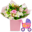 A bright, uplifting baby girl floral gift is shown against a crisp white background, every detail carefully arranged to suggest celebration and tenderness. In the middle of the scene stands a sturdy, pastel pink box, its square shape offering a contemporary base for a generously full bouquet. The flowers look freshly arranged, like something you might see on a windowsill in North Oxford, catching the soft afternoon light. A single bright pink gerbera daisy sits proudly at the centre, its smooth petals fanning out in a perfect circle. Around it cluster fluffy white chrysanthemums, their intricate, many-petalled heads giving volume and a gentle, cloud-like feel. Light pink and white alstroemeria lilies, with their subtle speckles and curved petals, weave between the other flowers, while creamy yellow lily buds stretch slightly upwards, still closed and full of promise. Accents of vivid lime-green button blooms break up the softer shades, and clusters of deep red hypericum berries add small, jewel-like dots of colour. The greenery is lush and varied: glossy dark leaves and delicate fern fronds frame the blooms and spill casually over the top of the box, suggesting abundance without feeling crowded. All of this is wrapped in soft pink tissue and a veil of clear cellophane, which catches the light and hints at the crinkle of wrapping as the gift is opened. To the right, a metallic foil balloon in the whimsical shape of a baby pram adds a playful note. The balloon gleams in bright pink with a purple hood and matching purple wheels, each wheel decorated with multicoloured spokes, and bears the words It's a Girl! in bold yellow and green letters. The image as a whole evokes the joy of bringing a new baby girl home in Oxford, perhaps to a quiet street near Christ Church Meadow or a family house close to Florence Park.