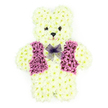 In this photograph, a three-dimensional teddy bear made entirely from fresh flowers sits serenely against a pure white background, every detail sharply defined yet deeply tender. The bear's body is covered in compact, creamy white chrysanthemums, arranged so closely that they create an even, cushion-like texture over the rounded head, plump belly, short arms, and sturdy legs. The petals appear slightly ruffled at the edges, lending the impression of soft, brushed fur, similar to the gentle textures you might notice on a misty walk through Oxford's University Parks. The face is simple but expressive: two small, dark floral centres serve as bright, attentive eyes, and another forms the nose, with subtle shaping beneath suggesting a sweet, reassuring smile. Draped across the front of the teddy is a striking floral vest rendered in rich purple tones, built from clusters of purple and mauve flowers that form a tailored, V-shaped design with neat lapels. Around the neck sits a light lavender mesh bow, its fine netting forming a graceful knot and flowing loops, giving a hint of playful formality. The entire tribute feels both childlike and dignified, ideal for a funeral or memorial where tenderness and remembrance are at the forefront. This is the sort of bespoke floral teddy bear we often create for families across Oxford-whether for a small chapel service in Cowley or a more formal farewell in the city centre-offering a symbolic hug made of petals, colour, and care.